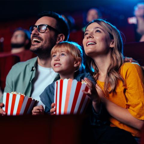 Family of three watching movie in a theater