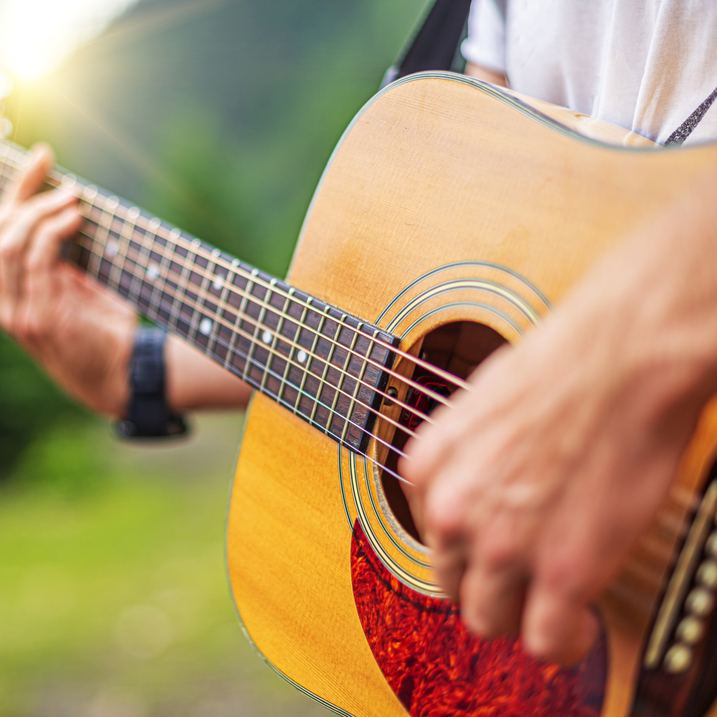 Someone playing  guitar
