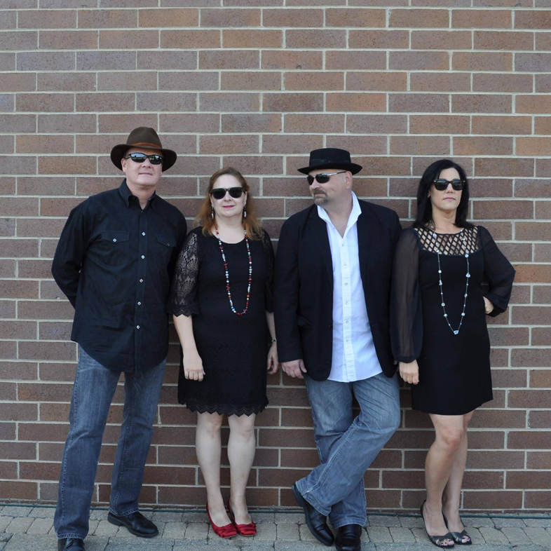 The Messengers band members against a brick wall