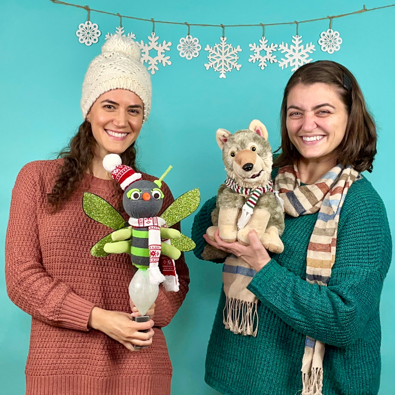 Two women holding puppets