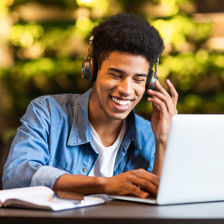 Teen listening to music while on computer