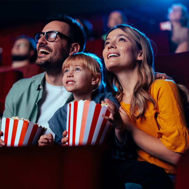 Family watching a movie in the theater