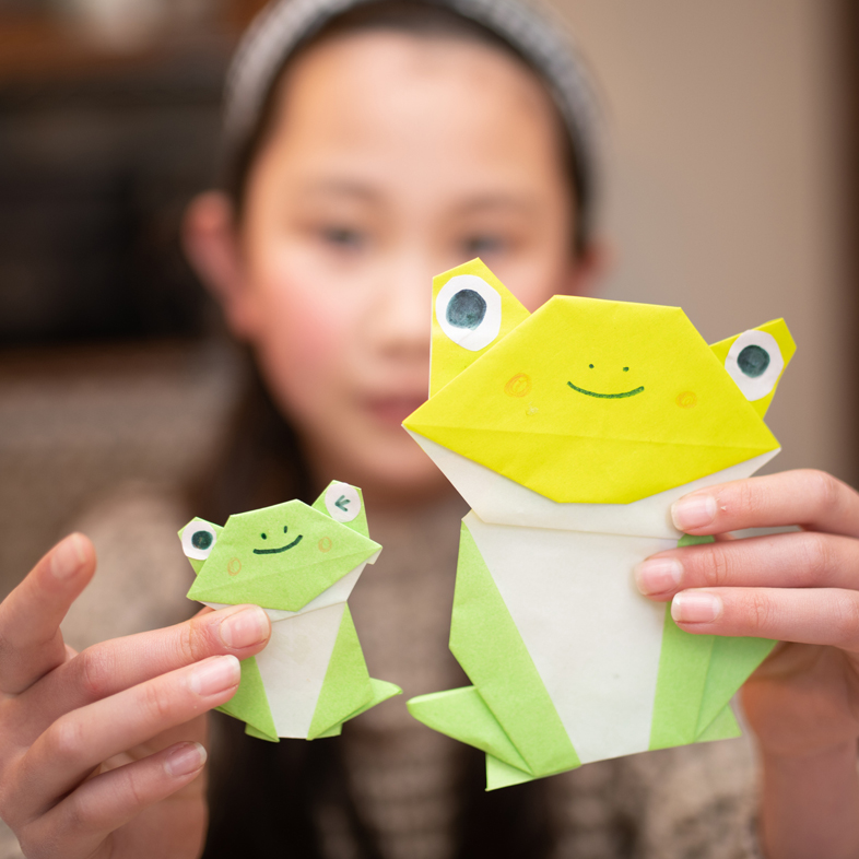 Girl holding frog origami