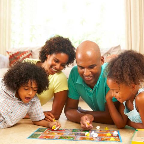Family of four playing a board game