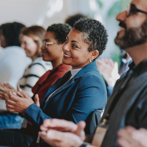 Woman in audience clapping