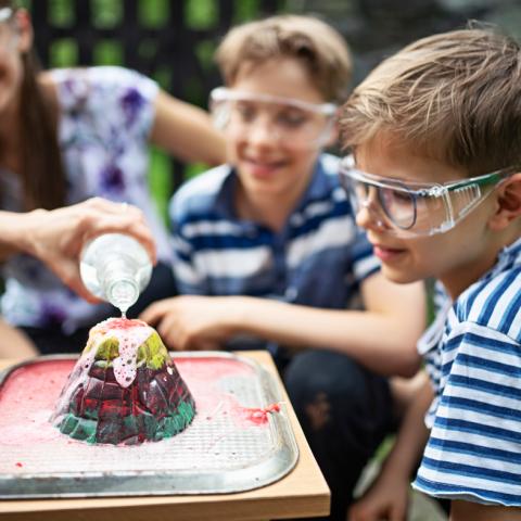 Two tween boys working on volcano experiment
