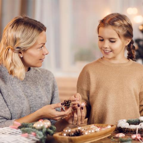 Mother and daughter working on wreath