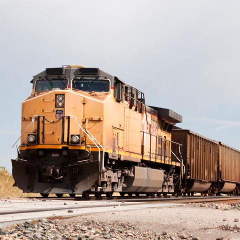Freight train engine pulling multiple cars