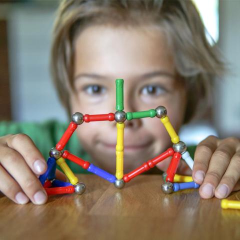 Boy playing with magnet toy