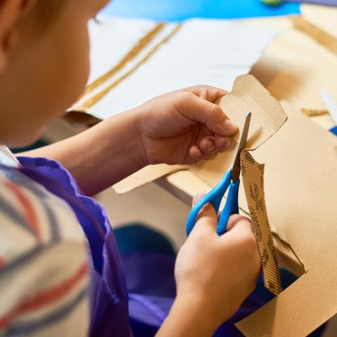 Child cutting cardboard
