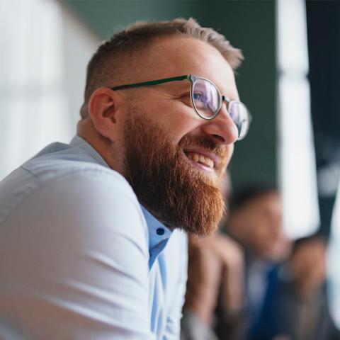 Man in conversation smiling