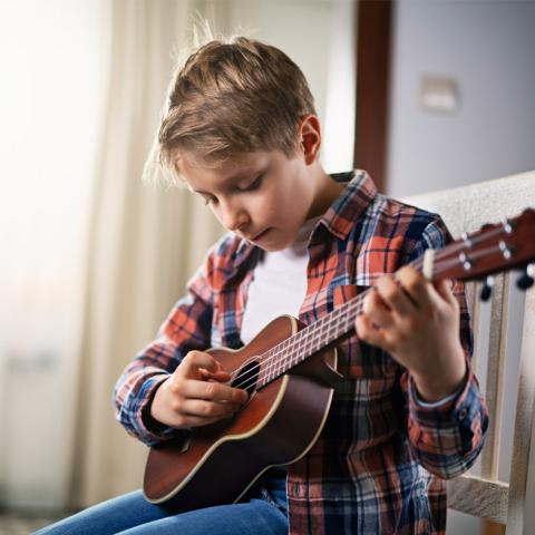 Boy playing ukulele