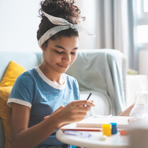 Teen crafting at a table