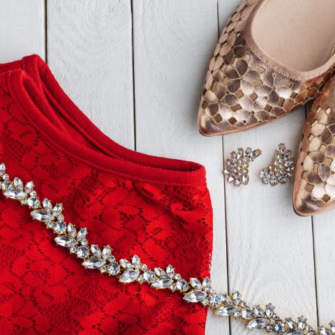 Red dress, gold shoes, and diamond necklace