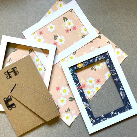 framed photo mat covered in fabric and craft supplies