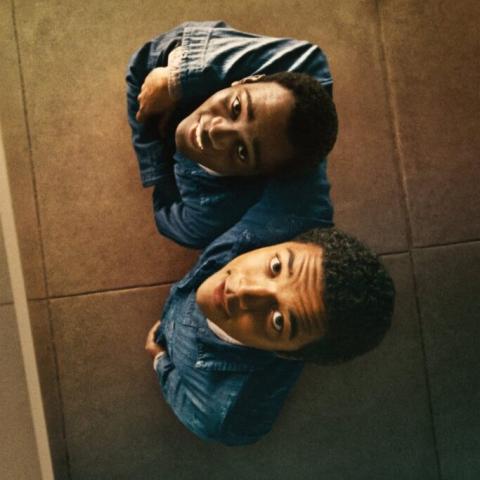 two African American young men looking up