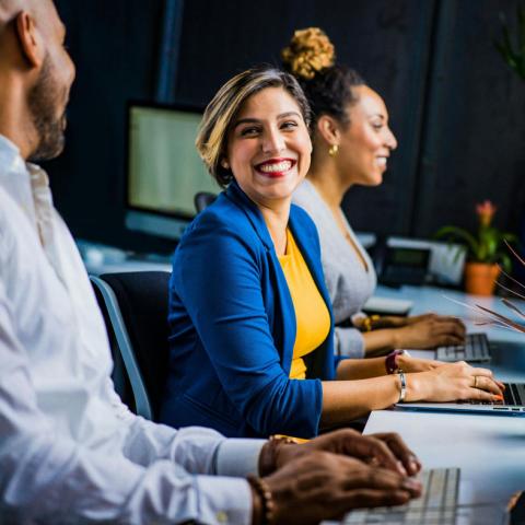 Team members smiling at eachother