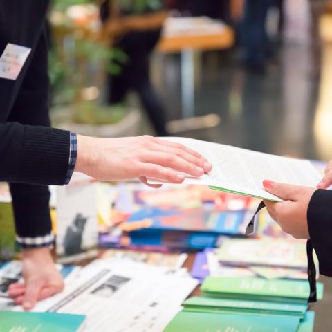 Person giving information at info booth