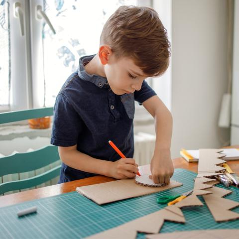 Child measuring cardboard