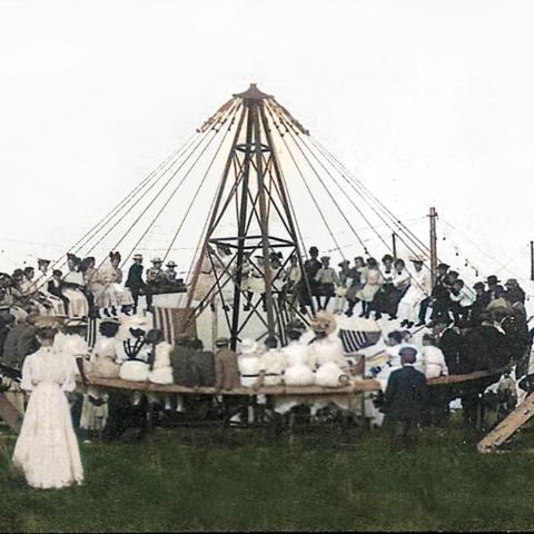 people in historical clothes on old fashioned amusement ride
