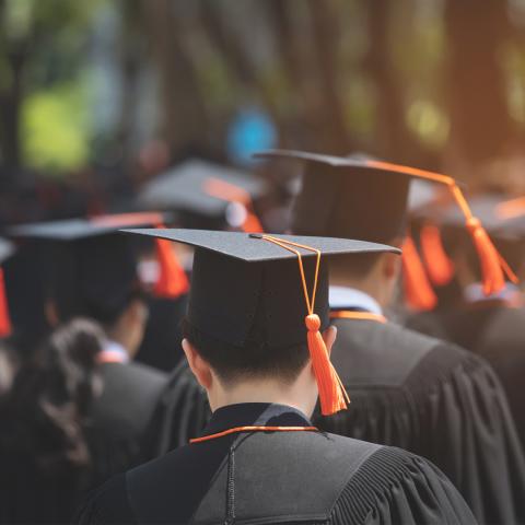 Students wearing graduation cap and gown
