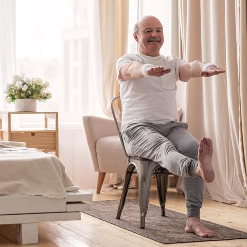 man doing exercises while seated