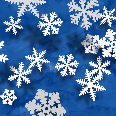 Paper snowflakes on blue background