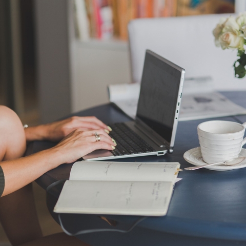 Person working at kitchen table on their laptop