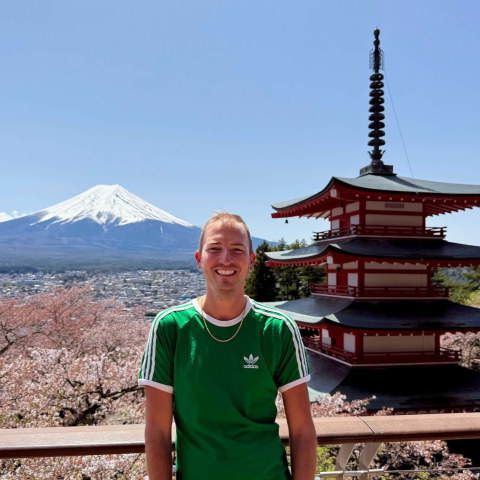 Presenter in front of pagoda, cherry blossoms and Mt. Fuji, Japan
