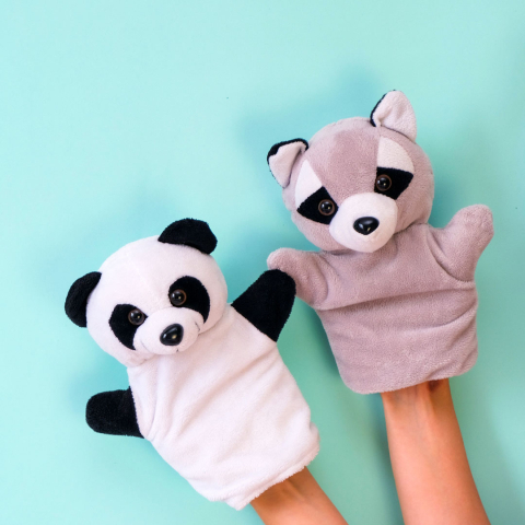 Panda and racoon hand puppets on blue background