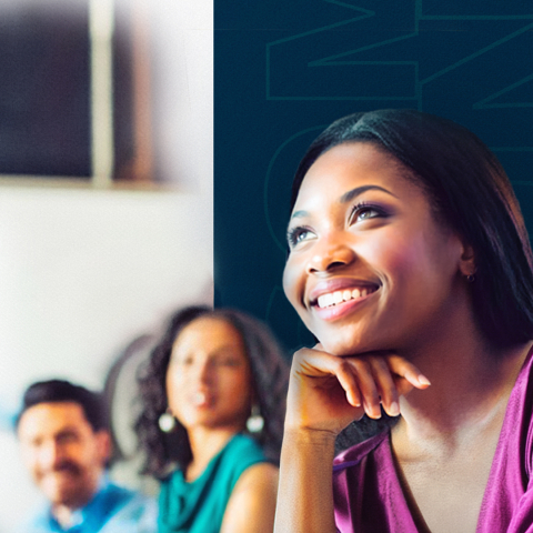 Woman smiling and looking up at a table with others