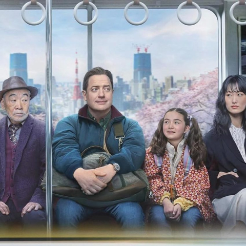 Four actors sitting on Japanese train