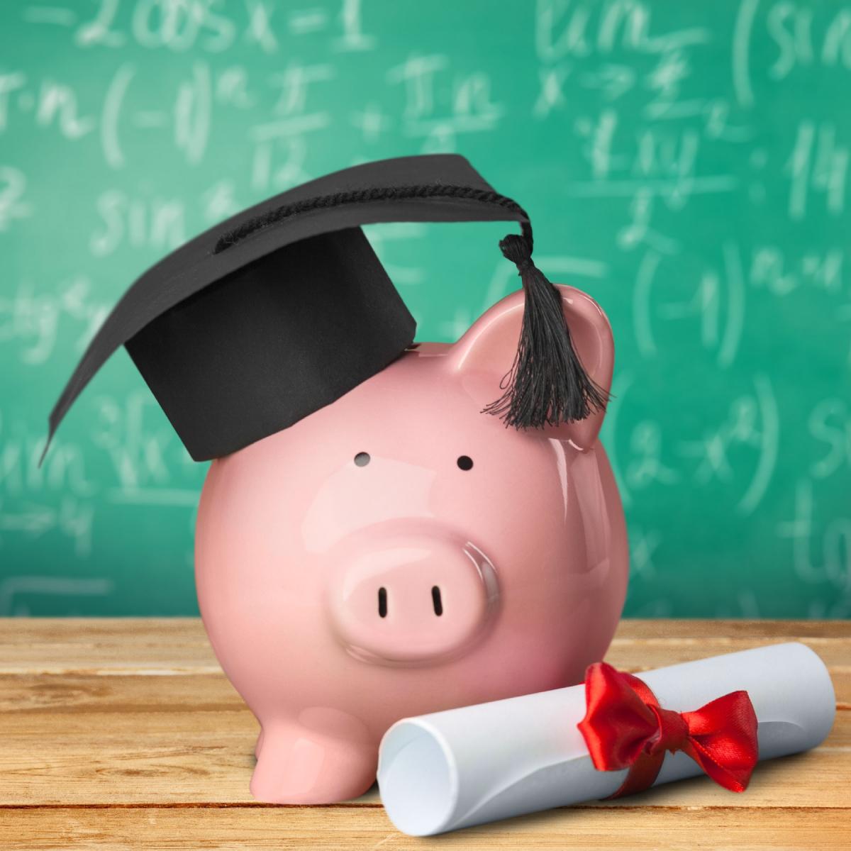 Piggy bank with graduation cap and diploma