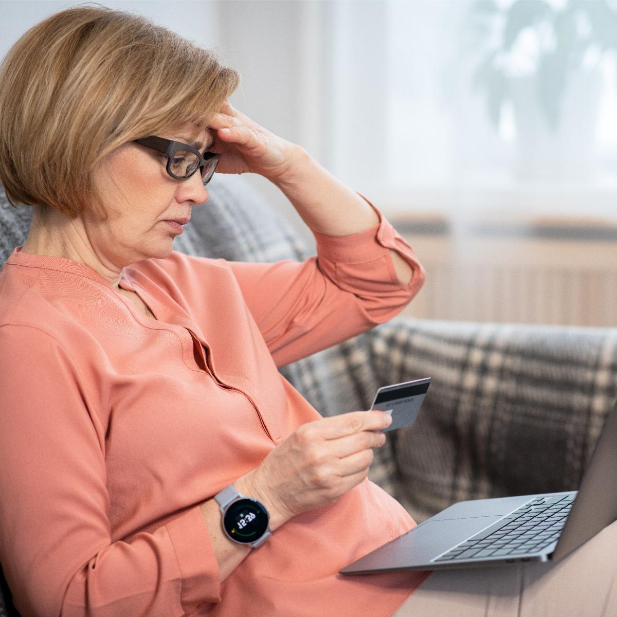Woman sitting on a couch looking at the computer