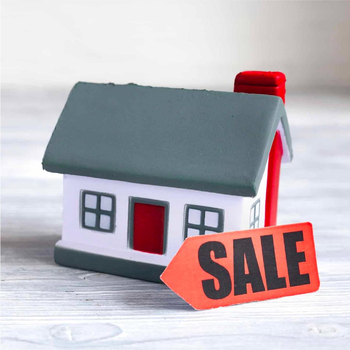 House with sale sign out front