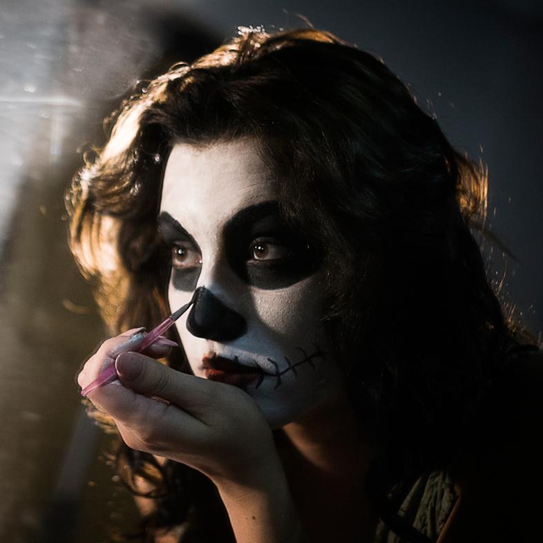 Girl applying skeleton makeup