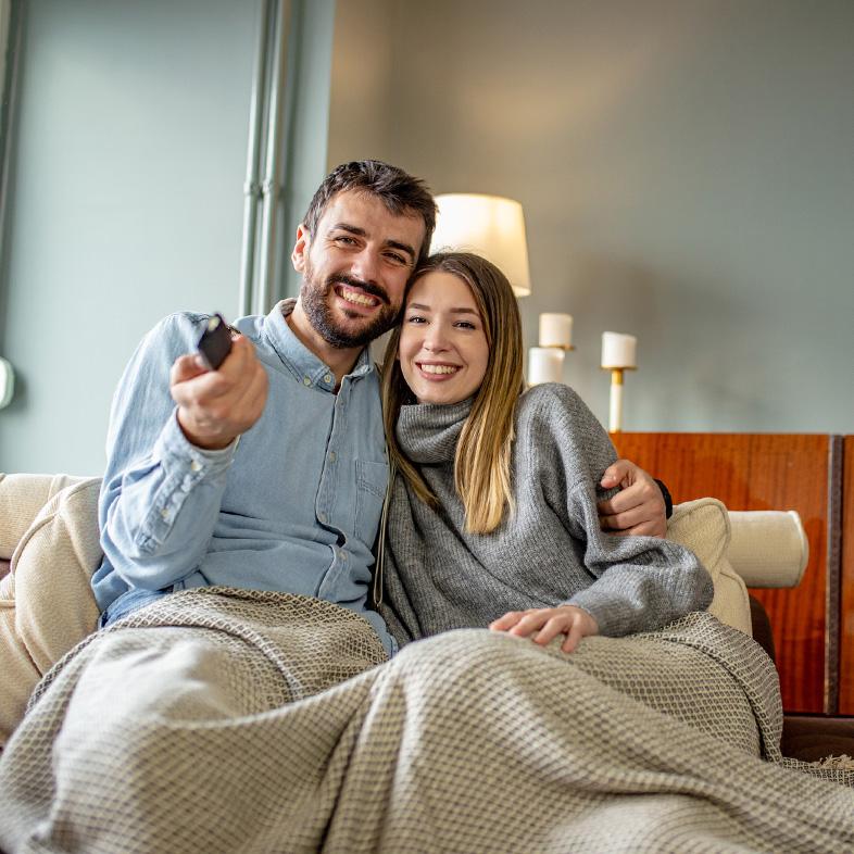 Couple on couch watching movie