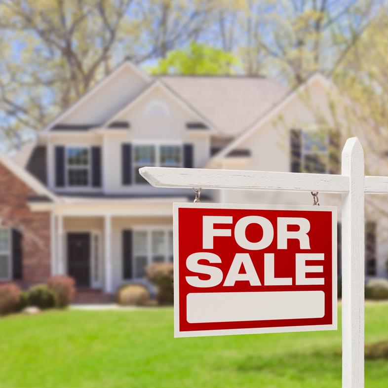 Home with "For Sale" sign out front