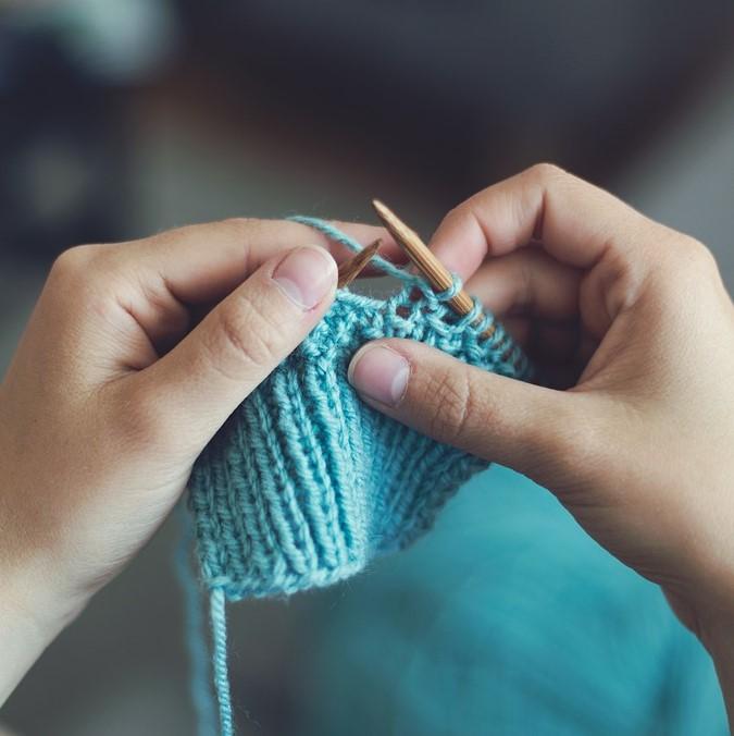 Person knitting with two knitting needles