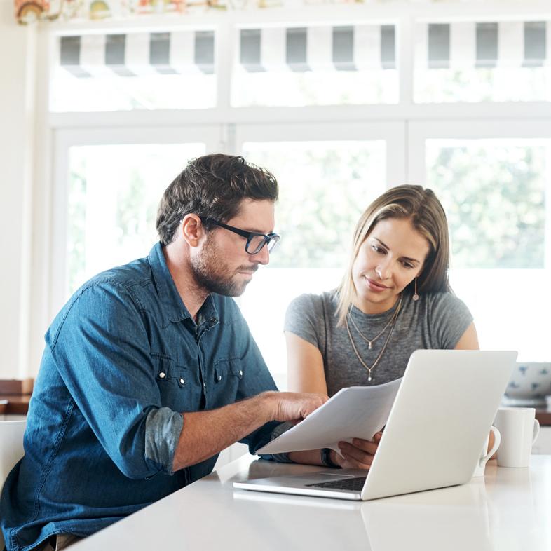 Couple reviewing document at computer
