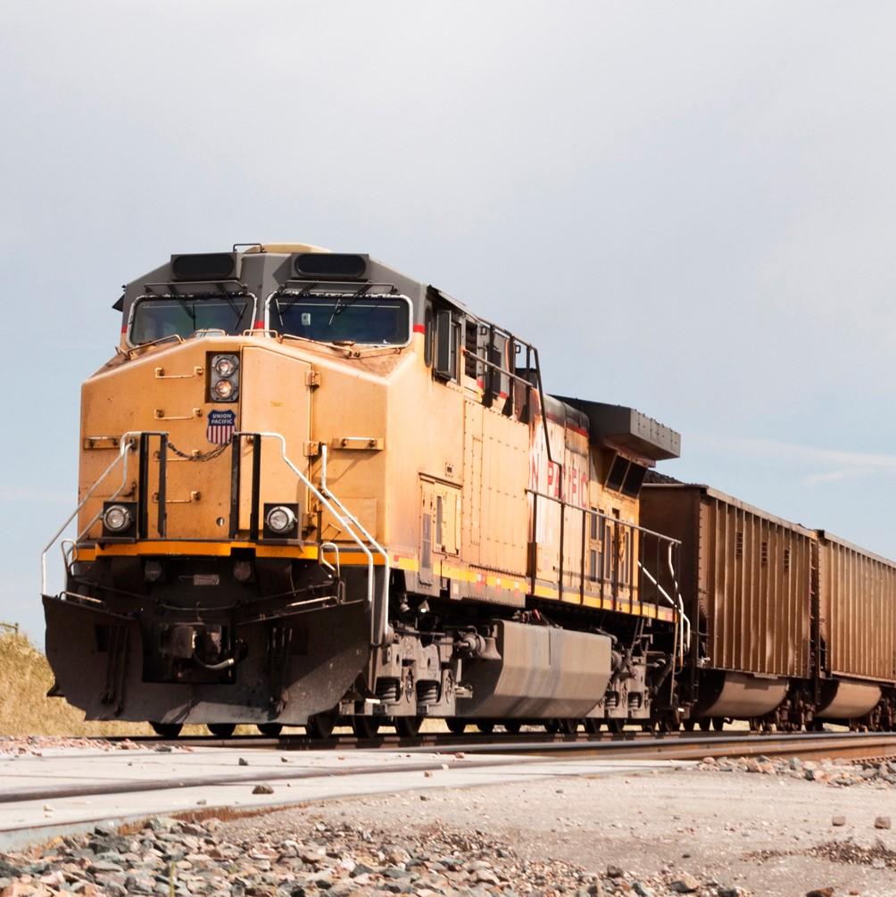Freight train engine pulling multiple cars