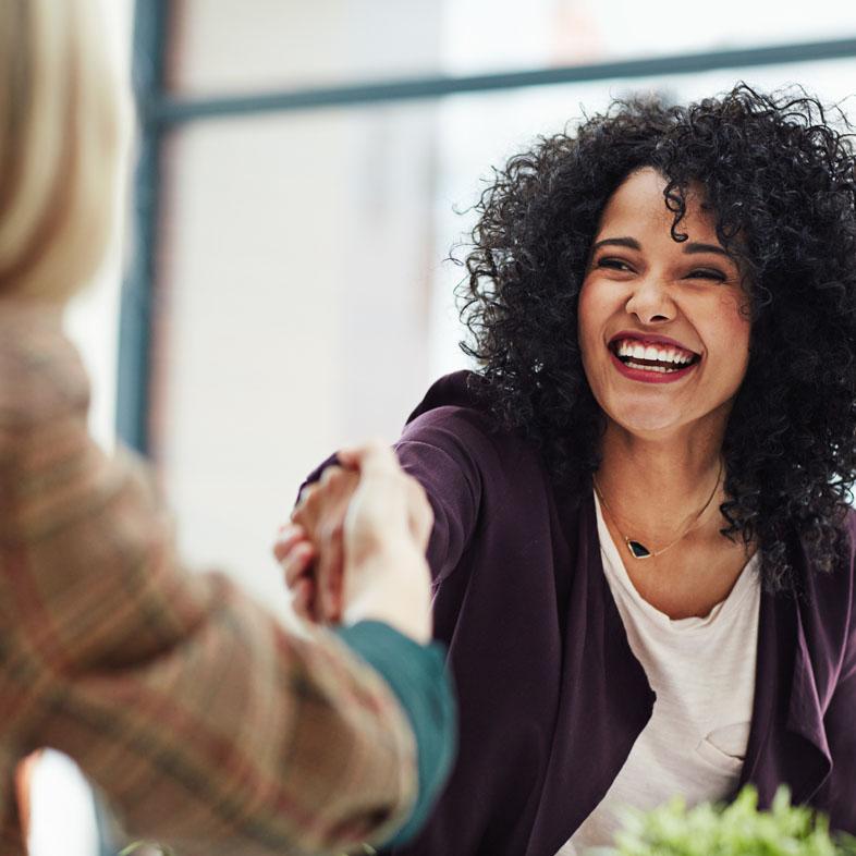 Woman shaking interviewer's hand