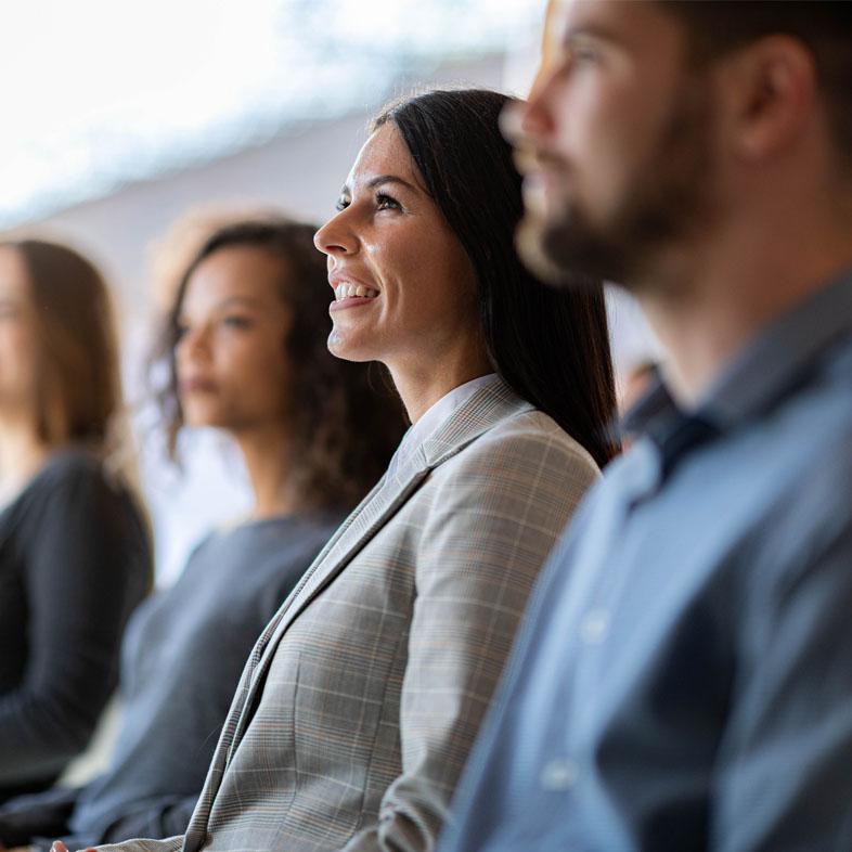 Woman in audience listening to presentation