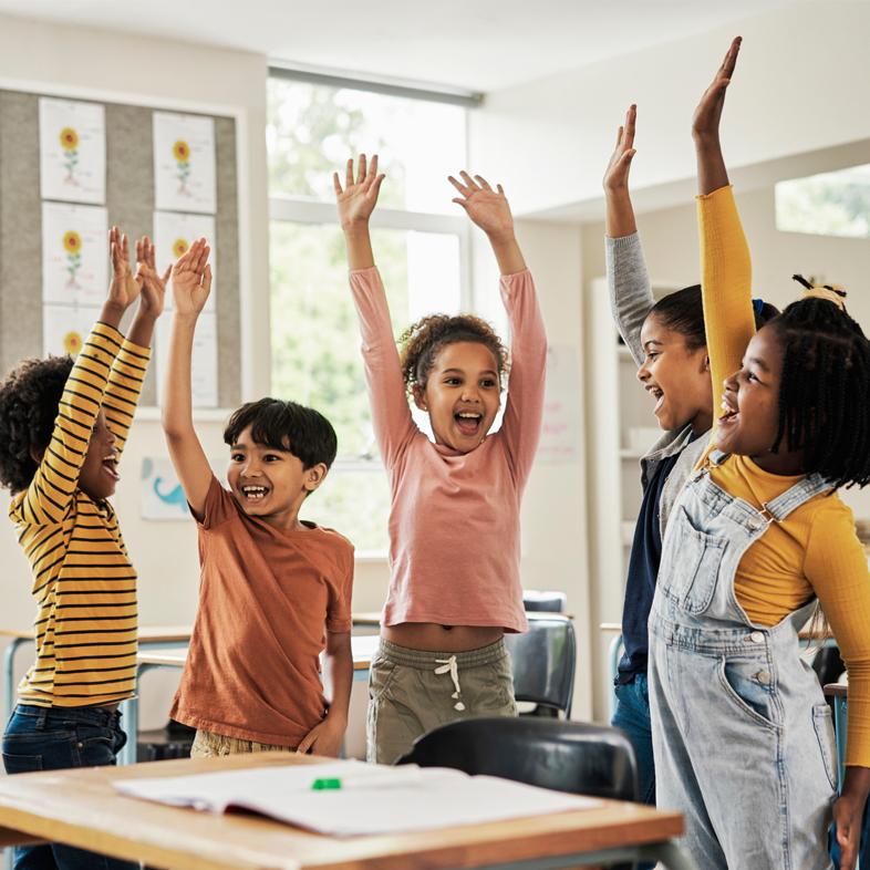 Group of children raising hands