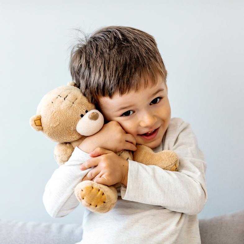 Child holding teddy bear