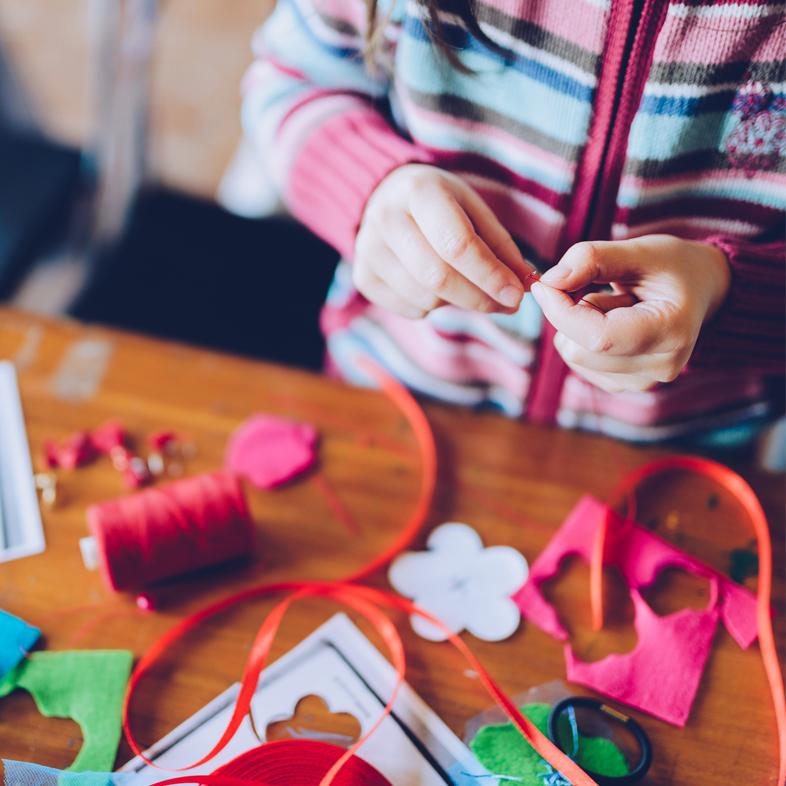 Child holding craft supplies