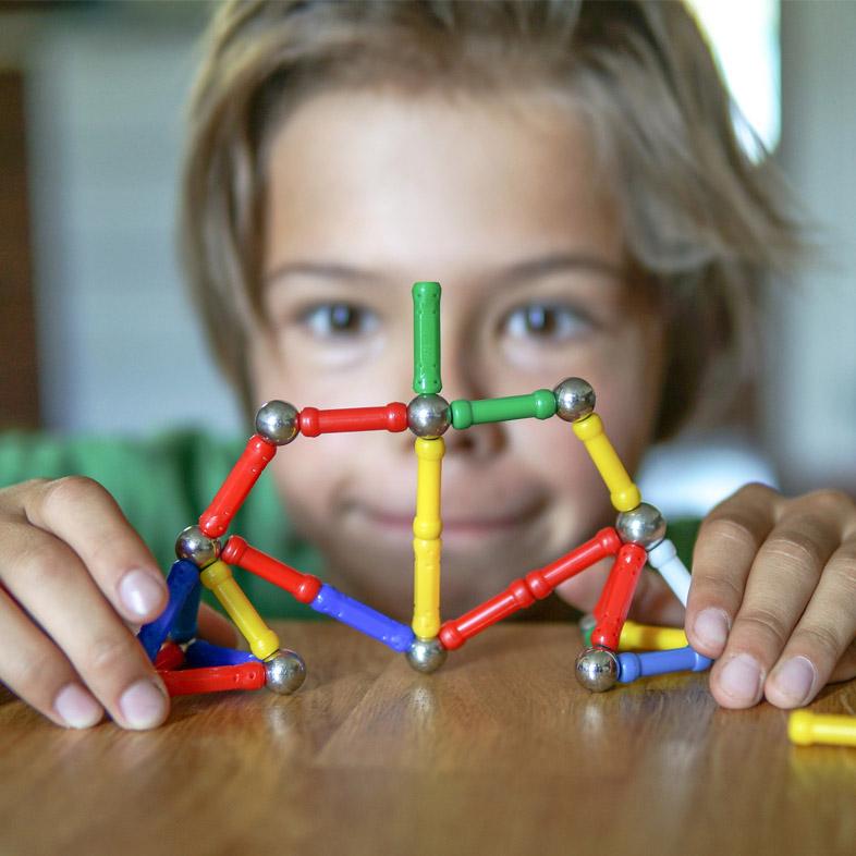 Boy playing with magnet toy