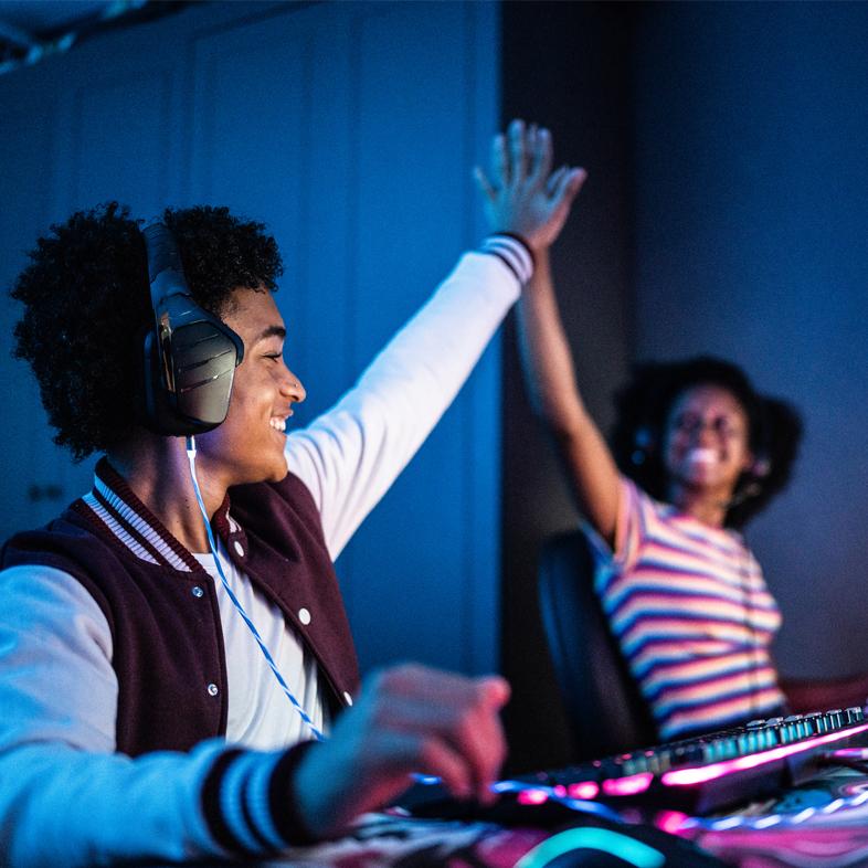 Teens on computer high fiving