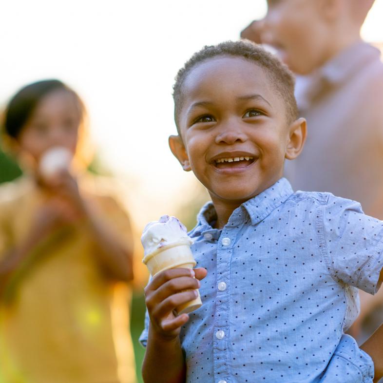 Boy eating ice cream outside