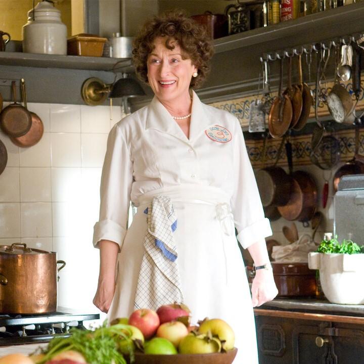 Actress Meryl Streep portraying chef Julia Child in kitchen